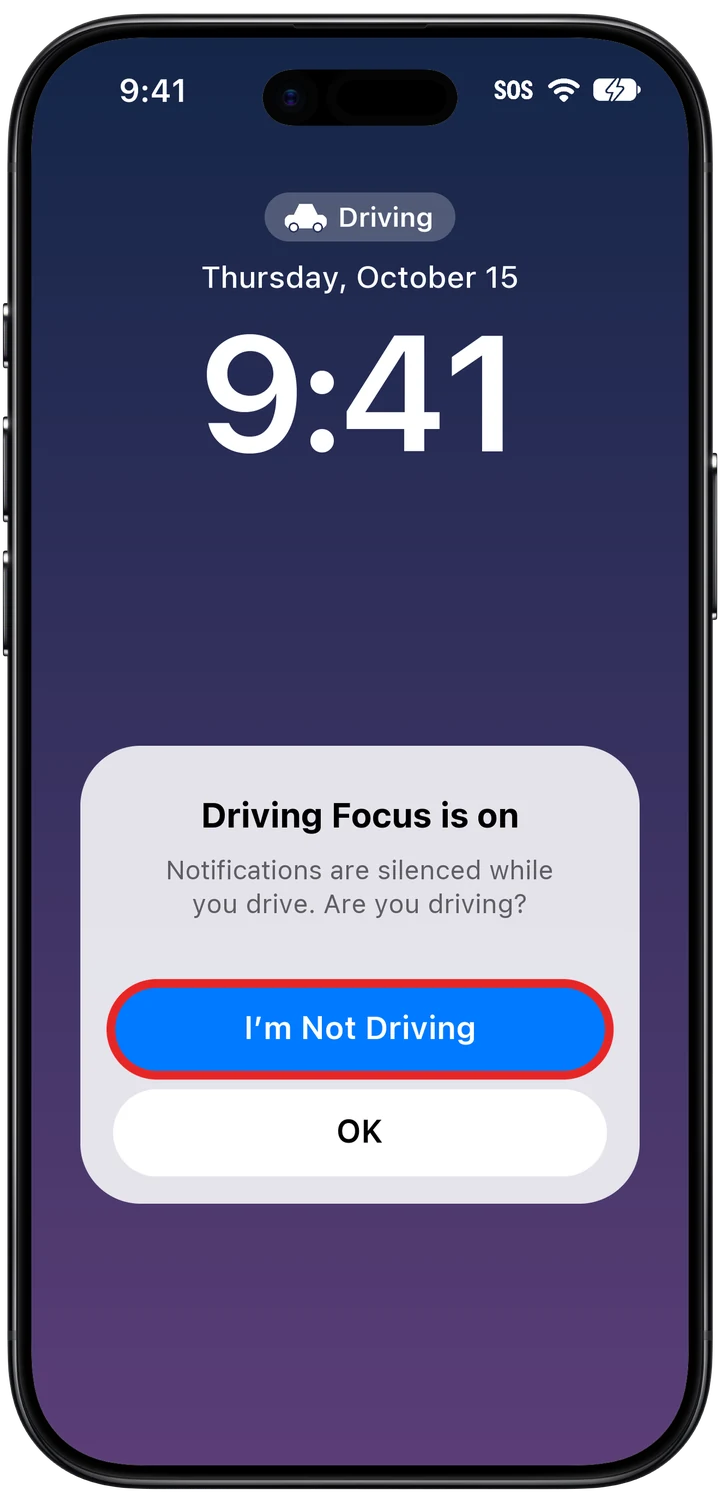 The Driving Focus prompt on the Lock Screen with the I'm Not Driving button marked in red